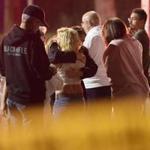 People comfort each other as they stand near the scene Thursday, Nov. 8, 2018, in Thousand Oaks, Calif. where a gunman opened fire Wednesday inside a country dance bar crowded with hundreds of people on 