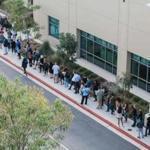 People wait in line to cast their ballot at a polling station in San Diego Tuesday. 