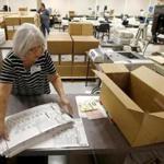 Workers at the Maricopa County Recorder's Office go through ballots. 