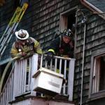 11/09/2018 Dorchester Ma-A Boston Firefighter drops a air coditioner from a deck at 18 Victoria Street in Dorchester, where their was a two alarm fire. Jonathan Wiggs /Globe Staff Reporter:Topic: