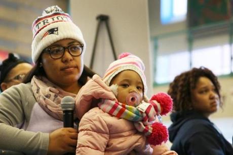 Jennifer DeJesus, 26, held her daughter Amalia DeJesus, 1, as she asked a question at Lawrence High School during a Saturday open house for those affected by the gas explosions.  
