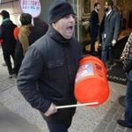 Boston, MA - 11/08/18 - Valter Mucaj (cq) bangs a plastic bucket and shouts union slogans in front of the Ritz as patrons exit the lobby. Banging on makeshift drums and shouting slogans, UNITE HERE Local 26 hotel workers are on strike at seven Marriott hotels in Boston, including in front of the Ritz Carlton. Residents of the swanky Millennium Place condos are used to putting on the ritz, but for the last six weeks they've been putting up with The Ritz: A cacophonous, 12-hour-a-day racket led by striking Marriott workers. Now, three condo associations from buildings nearby (but not associated with the labor dispute) are suing the city to get police to enforce noise ordinances in the first class action permit case in recorded history. (Lane Turner/Globe Staff) Reporter: (ramos) Topic: (09nestorritz)