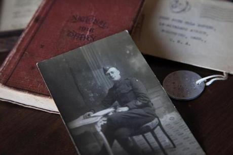 Anne Rodier displayed a photograph of her grandfather, Joe Rodier, along with his diary, dog tag, and a letter to her aunt, at her home in Kennebunk, Maine. Joe Rozier was a 24-year-old Massachusetts soldier in the US Army during World War I.
