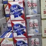 In this photo taken on Thursday, Nov. 8, 2018, cases of Pabst Blue Ribbon and Coors Light are stacked next to each other in a Milwaukee liquor store. Pabst Brewing Company and MillerCoors are heading to trial starting Monday, Nov. 12, to settle a contract dispute in which Pabst accuses the brewing giant of trying to undermine its competitor by breaking a contract to make their products. (AP Photo/Ivan Moreno)