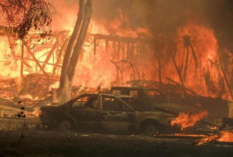 A wildfire burns a structure near Malibu Lake in Malibu, Calif., Friday, Nov. 9, 2018. About two-thirds of the city of Malibu was ordered evacuated early Friday as a ferocious wildfire roared toward the beachside community that is home to about 13,000 residents, some of them Hollywood celebrities. (AP Photo/Ringo H.W. Chiu)
