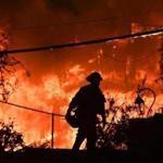 A firefighter was silhouetted by a burning home along Pacific Coast Highway (Highway 1) during the Woolsey Fire in Malibu, Calif. 