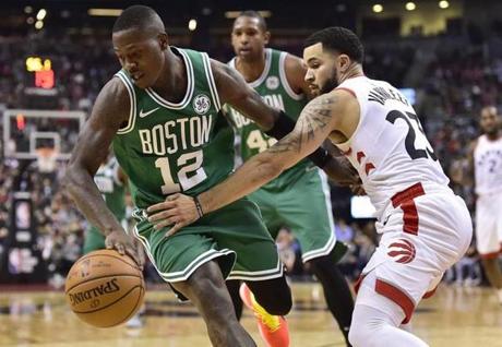 Boston Celtics guard Terry Rozier (12) moves past Toronto Raptors guard Fred VanVleet (23) during second-half NBA basketball game NBA action in Toronto, Friday, Oct. 19, 2018. (Frank Gunn/The Canadian Press via AP)
