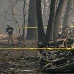 PARADISE, CA - NOVEMBER 15: A police officer stretches crime scene tape around an area where human remains were found in a car that was destroyed by the Camp Fire on November 15, 2018 in Paradise, California. Fueled by high winds and low humidity the Camp Fire ripped through the town of Paradise charring over 140,000 acres, killed at least 56 people and has destroyed over 8,500 homes and businesses. The fire is currently at 40 percent containment. (Photo by Justin Sullivan/Getty Images)