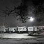 Snow fell on trailers set up in Lawrence, Mass., to house people displaced by the gas explosions two months ago.  