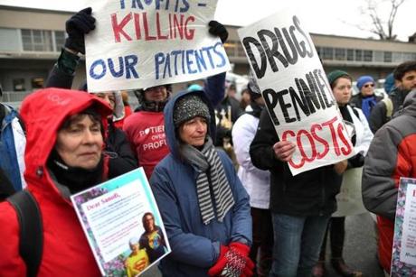 Protesters gathered in front of Sanofi in Cambridge on Friday.
