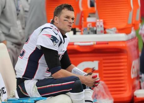 Tom Brady sits on the bench after getting pulled midway through the fourth quarter of last Sunday?s loss to the Titans. 

