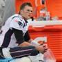 Tom Brady sits on the bench after getting pulled midway through the fourth quarter of last Sunday?s loss to the Titans. 