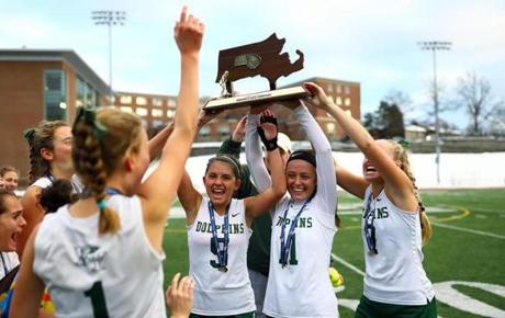  Dennis-Yarmouth field hockey captains hoist their Divison 2 state championship trophy, after defeating Greenfield. 

