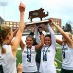  Dennis-Yarmouth field hockey captains hoist their Divison 2 state championship trophy, after defeating Greenfield. 