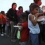 Central American migrants waited to receive donated dinner in downtown Mexicali, Mexico, on Monday.