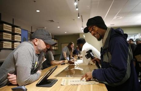 LEGAL POT SLIDER Leicester, MA, 11/19/2018 -- Adam Spencer, 34, (R) talks over his selection with a budtender for the opening of Cultivate, one of the state's first two pot shops. This the first day the store can sell recreational marijuana to adults 21 and older. (Jessica Rinaldi/Globe Staff) Topic: 21potopen Reporter: 
