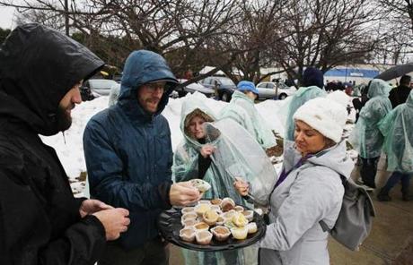 LEGAL POT SLIDER Northampton, MA - 11/20/2018- ] NETA employee Nicole Heisler, 38, of Watertown, passes out muffins to people standing in to purchase recreational marijuana at the Northampton facility on Tuesday, November 20, 2018. (Michael Swensen for The Boston Globe) Topic: (metro) 
