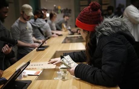 LEGAL POT SLIDER Leicester, MA, 11/19/2018 -- Brittani Beeso, 23, of Worcester purchases marijuana at the opening of Cultivate, one of the state's first two pot shops. This the first day the store can sell recreational marijuana to adults 21 and older. (Jessica Rinaldi/Globe Staff) Topic: 21potopen Reporter: 
