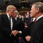 (FILES) In this file photo taken on February 28, 2017, US President Donald Trump (L) shakes hands with US Supreme Court Chief Justice John Roberts (R) as Trump arrives to deliver his first address to a joint session of Congress in Washington, DC. - Chief Justice Roberts issued an extraordinary rebuke of Trump on November 21, 2018, after the president criticized a ruling he said was handed down by an 