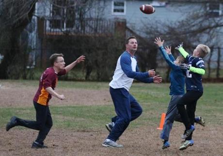 Mystic, CT - 11/18/2018- ] William Korinek, CEO of Astrocyte Pharmaceuticals, plays tag football at ST Butler Elementary School in Mystic with his two sons and longtime friends on Sunday, November 19, 2018. Korinek and Astrocyte Pharmaceuticals are now developing a drug to treat concussions. (Michael Swensen for The Boston Globe) Topic: (business)
