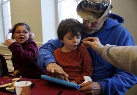 Ryker (center), 3, and Annalyse Rivera, 6, of South Lawrence ate with relatives Joe Rivera and Rosalie Davis in Andover.
