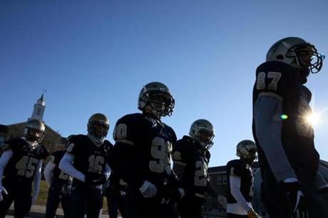 Needham, MA - November 22, 2018: Members of the Needham High School football team take the field prior to their 131st meeting with Wellesley High School in Needham, MA on November 22, 2018. High temperatures are only expected to reach the low 20s across Massachusetts, according to the weather service, and the wind chill will make it feel much colder during the morning hours. (Craig F. Walker/Globe Staff) section: metro reporter: 

