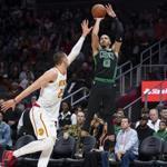 Boston Celtics forward Jayson Tatum (0) shoots as Atlanta Hawks center Alex Len defends during the first half of an NBA basketball game Friday, Nov. 23, 2018, in Atlanta. (AP Photo/John Amis)