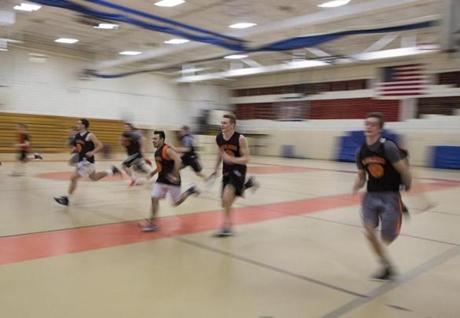 Members of the Marlborough High School boys basketball team run sprints during a 2015 practice.
