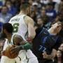 Dallas Mavericks forward Luka Doncic reacts after being blocked on a screen by Boston Celtics center Aron Baynes as teammate guard Kyrie Irving carries the ball in the first half of an NBA basketball game in Dallas Saturday, Nov. 24, 2018. (AP Photo/Andy Jacobsohn)