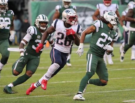 East Rutherford NJ 11/25/18 New England Patriots Sony Michel cuts against the grain during a long run against the New York Jets Jamal Adams (33) and Darryl Roberts (27) during fourth quarter action at MetLife Stadium. (photo by Matthew J. Lee/Globe staff) topic: reporter: 
