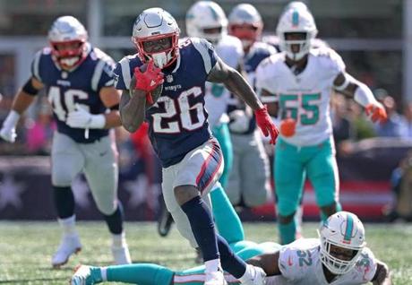 Foxborough, MA 09/30/18: Patriots running back Sony Michel (216) leaves the Dolphins Raekwon McMillan (52) in his wake on his way to a second qaurter 23 yard first down run. New England Patriots hosted the Miami Dolphins at Gillette Stadium Sunday, Sept. 30, 2018. (Jim Davis/Globe Staff)
