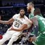 New Orleans Pelicans guard Ian Clark (2)3 drives to the basket against Boston Celtics center Aron Baynes and guard Terry Rozier (12) in the first half of an NBA basketball game in New Orleans, Monday, Nov. 26, 2018. (AP Photo/Gerald Herbert)