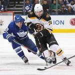 TORONTO, ON - NOVEMBER 26: Jake DeBrusk #74 of the Boston Bruins skates away from a checking Tyler Ennis #63 of the Toronto Maple Leafs during an NHL game at Scotiabank Arena on November 26, 2018 in Toronto, Ontario, Canada. The Maple Leafs defeated the Bruins 4-2. (Photo by Claus Andersen/Getty Images)