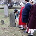 Reenactors from the Boston Tea Party Ships & Museum placed commemorative markers on graves of patriots who participated in the protest.  