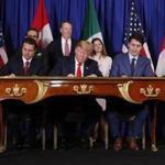 President Donald Trump (center), Canada's Prime Minister Justin Trudeau (right), and Mexican President Enrique Pena Neto, left, participate in the USMCA signing ceremony Friday in Buenos Aires, Argentina. 