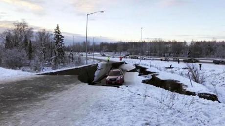A car was trapped on a collapsed section of the offramp in Anchorage on Friday.

