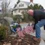 Milton, MA - 12/1/2018 -Jack Guinan of Dedham MA, places US Flags at the roadside marker in front of the house where The 41st President of The United States George H.W. Bush was born, Milton Massachusetts. (John Cetrino for The Boston Globe) Reporter Hilliard
