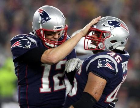 Tom Brady (left) congratulated fullback James Develin on one of his two touchdowns.
