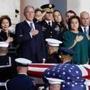 Members of the Bush family, including former President George W. Bush, watched Monday as the flag-draped coffin of George H.W. Bush arrived at the US Capitol.