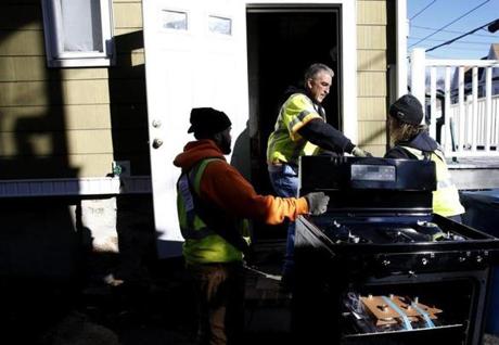 Lawrence, MA, 12/3/2018 -- Workers deliver a new stove to a home in South Lawrence. (Jessica Rinaldi/Globe Staff) Topic: 04lawrence Reporter: 
