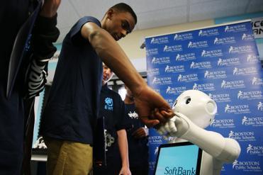 Jaheim Boles, 15, a student at English High School in Jamaica Plain, greeted the robot introduced to aid in computer programming.

