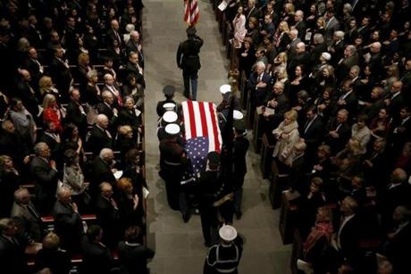 The flag-draped casket of former President George H.W. Bush is carried by a joint services military honor guard into St. Martin's Episcopal Church Thursday, Dec. 6, 2018, in Houston. (AP Photo/Mark Humphrey)
