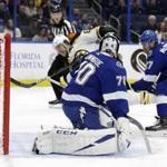 Boston Bruins right wing David Pastrnak (88) beats Tampa Bay Lightning goaltender Louis Domingue (70) for a goal during the first period of an NHL hockey game Thursday, Dec. 6, 2018, in Tampa, Fla. Defending for the Lightning is Ryan McDonagh (27). (AP Photo/Chris O'Meara)