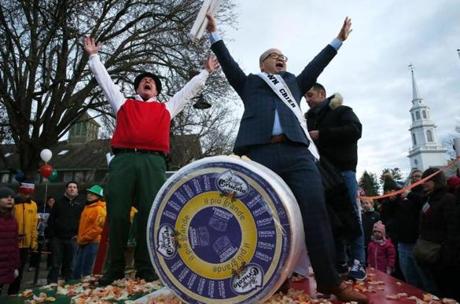 Peter Lovis (left), owner of The Cheese Shop, and ?town crier? Steve Ng celebrated the arrival of the 400-pound cheese wheel.
