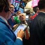 Traders work on the floor at the opening bell of the Dow Industrial Average at the New York Stock Exchange on December 6, 2018 in New York. - Wall Street opened sharply lower Thursday, joining a global stocks sell-off after the arrest of a key Chinese executive at Washington's request revived worries over trade tensions. About three minutes into trading, the Dow Jones Industrial Average had fallen 2.0 percent, nearly 500 points, to 24,532.25. The broad-based S&P 500 sank 1.9 percent to 2,648.04, while the tech-rich Nasdaq Composite Index shed 2.2 percent to 7,002.02. (Photo by Bryan R. Smith / AFP)BRYAN R. SMITH/AFP/Getty Images