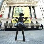 The Fearless Girl statue is unveiled at her new home facing the New York Stock Exchange (NYSE) during an event on December 10, 2018 held by the city of New York and State Street Global Advisors. (Photo by TIMOTHY A. CLARY / AFP)TIMOTHY A. CLARY/AFP/Getty Images