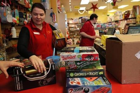 Jamaica Plain, MA., 12/12/2018, At the Boing toy store, employees, Deva Jasheway , cq, on left, prepare to wrap and shif gifts. Amid the downfall of Toys 