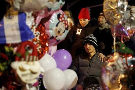 Edgar Mejia was consoled by his sister during a vigil for his two daughters Thursday night in Revere.
