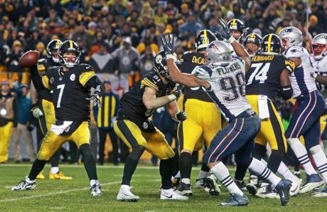 Pittsburgh, PA 12-17-17: Steelers quarterback Ben Roethlisberger (7), after his faked spike move, throws a pass to wide reciever Eli Rogers (not pictured) in the end zone that would end up being tipped by the Patriots Eric Rowe (not pictured) and intercepted by New England's Duron Harmon (not pictured), wrapping up the win for the Patriots. The New England Patriots visited the Pittsburgh Steelers for an NFL regular season football game. (Jim Davis/Globe Staff)
