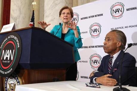 The Rev. Al Sharpton listened to Senator Elizabeth Warren last month. Sharpton says he was surprised by her ability to connect with black voters with her words and actions.
